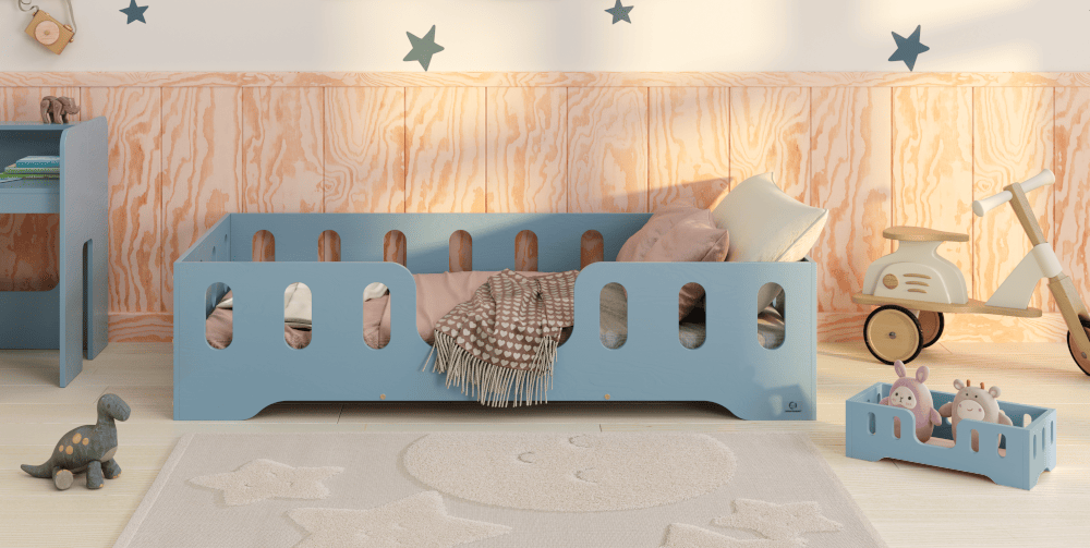 Drewniane niebieskie łóżko z podłużnymi wycięciami w barierkach i wejściem na środku oraz jego miniatura dla lalek